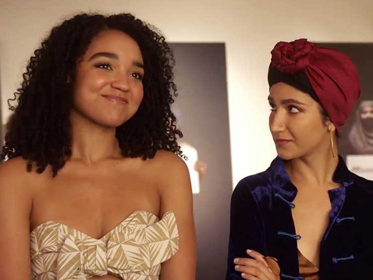Kat (Aisha Dee) smiling to the left as Adena ( Nikohl Boosheri) to the right watched 